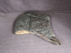 A WWII German Luftwaffe Leather Flying Helmet, dark brown leather with wool lining, leather tying