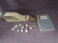 A Kings Own Webbing Belt with Buckle, Kings Own Cap Badge, Buttons and a Merchant Marine Seaman's