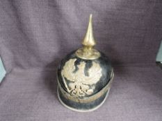 A German leather Pickelhaube Helmet having helmet brass winged eagle Koenig FR, brass spike to