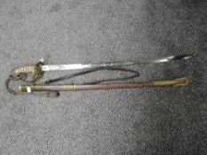 A British Naval Officers Sword with metal scabbard, sword has lion's head pommel and enclosed hilt