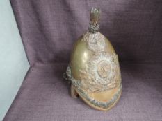 A 19th century Brass Helmet with The Royal Dragoons Helmet Plate having metal chin strap, af leather