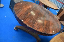 A William IV rosewood dining table having circular top on central column and trefoil platform