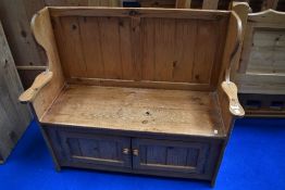 A natural pine box settle, having doors to front , width approx. 107cm
