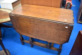 An early 20th Century oak pie crust twist gate leg dining table