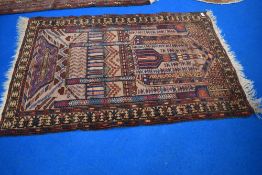 A Persian style prayer mat with imagery of religious buildings.