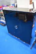 A modern side cabinet in the Art Deco style, in black gloss finish with chrome legs, by Next, some