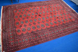A traditional carpet square having red ground, approx. 270 x 186cm