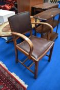 A 1950s oak carver chair having studded back and bentwood arms