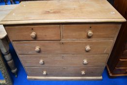 A Victorian stripped pine chest of two over three drawers