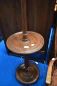 An early 20th Century mahogany standard lamp with integral table and handkerchief style fabric