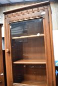 A modern Ercol mid stain bookcase with cupboard under