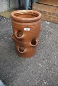 A clay planter, for strawberries etc