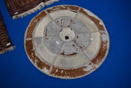 A circular animal hide throw.