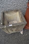 A composite stone effect cast garden planter.