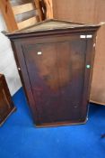 A 19th Century corner cupboard in oak.