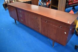 A vintage mahogany Long John style sideboard having cupboards to end with three drawers and drop