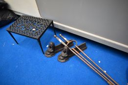 A pair of French cast fire dogs, fire tools and later footman