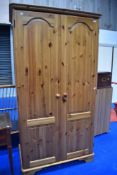 A modern Ducal style pine wardrobe