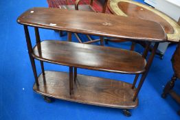 A dark stained Ercol trolley/bookcase, on replacement castors