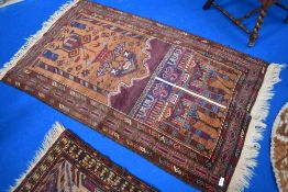 A Persian style prayer mat with imagery of religious buildings.