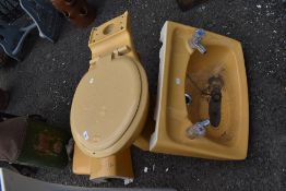 A mid century mustard yellow bathroom set.
