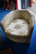 An early 20th century salon style tub chair.