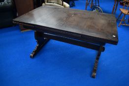 A Priory style oak drawer leaf refectory style dining table, probably Ercol