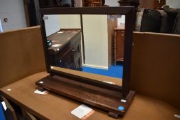 An early 20th century oak framed toilet mirror.
