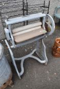 A vintage metal framed washing mangle.