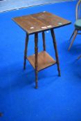 An Arts and Crafts style side table in golden oak with slight worm.