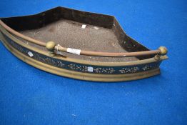 A vintage pierced brass fire fender.