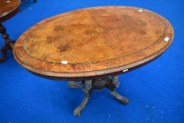 A 19th Century walnut occasional table having quarter veneered top, turned column and quadruple