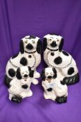 A pair of fireside staffordshire dogs and a pair of similar smaller size
