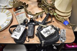 A selection of cameras and accessories, including Canon digital IXUS, a vintage GINO compact III