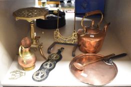 A vintage copper kettle, a copper griddle, a brass trivet on stand and more.