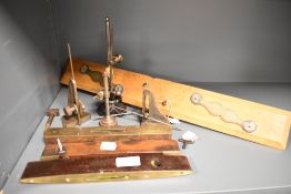 A selection of vintage tools/instruments including levels and rule