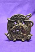 A cast metal penny bank, horse and hunting themed