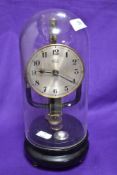 An early 20th Century Bulle electromagnetic clock having silver arabic dial, on ebonised base,