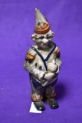 A 19th Century cast metal and painted penny bank, modelled as a clown