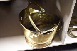A vintage brass coal helmet and a castcraft cast metal mirror, having gold tone finish.