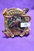 A cast metal and coloured penny bank, horse and hunting themed
