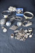A selection of silver and white metal jewellery including cuff links, charms, locket, bracelets etc