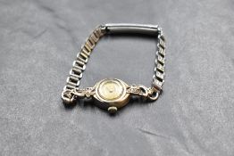 A ladies 9ct white gold cocktail watch by EMKA having baton numeral dial to small face in a white