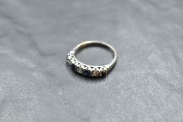 A sapphire and diamond half eternity ring having an illusionary setting on an 18ct white gold