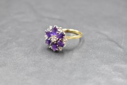 An amethyst and diamond daisy cluster ring having claw set basket mount and 18ct gold loop, size S &