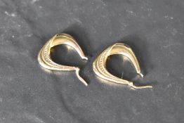 A pair of 9ct gold hoop earrings having moulded detail, approx 3.1g
