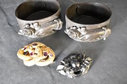 Two early flexible celluloid mourning bangles having moulded hand and rose decoration and a