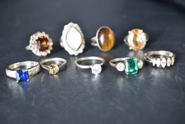 Nine white metal rings stamped silver including mother of Pearl, Tigers Eye, Cubic Zirconia etc
