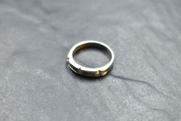 A 14k white metal and diamond set ring, having a linear arrangement of pressure-set diamond