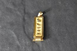 An 18ct Egyptian gold hieroglyphics pendant possibly spelling the name Avril, approx 9.3g
